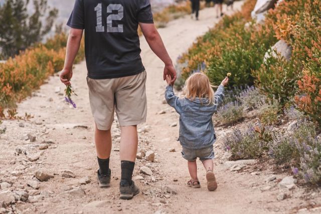 Father and daughter hiking on a summer day